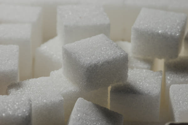 A close-up pile of white sugar cubes