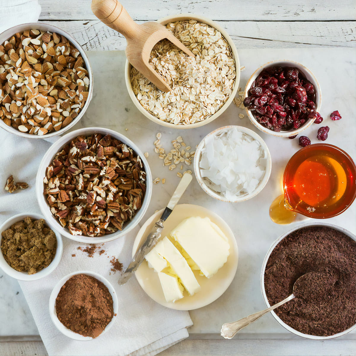 An overhead flat-lay of home baking ingredients in bowls