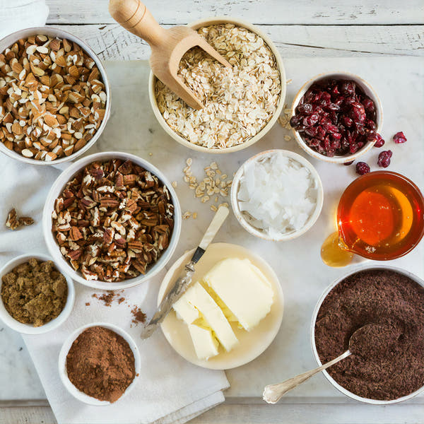 An overhead flat-lay of home baking ingredients in bowls
