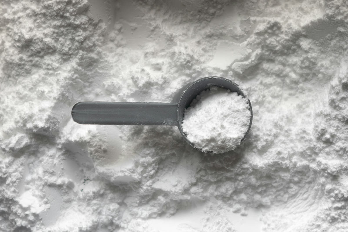 A measuring scoop of fine white monk fruit powder