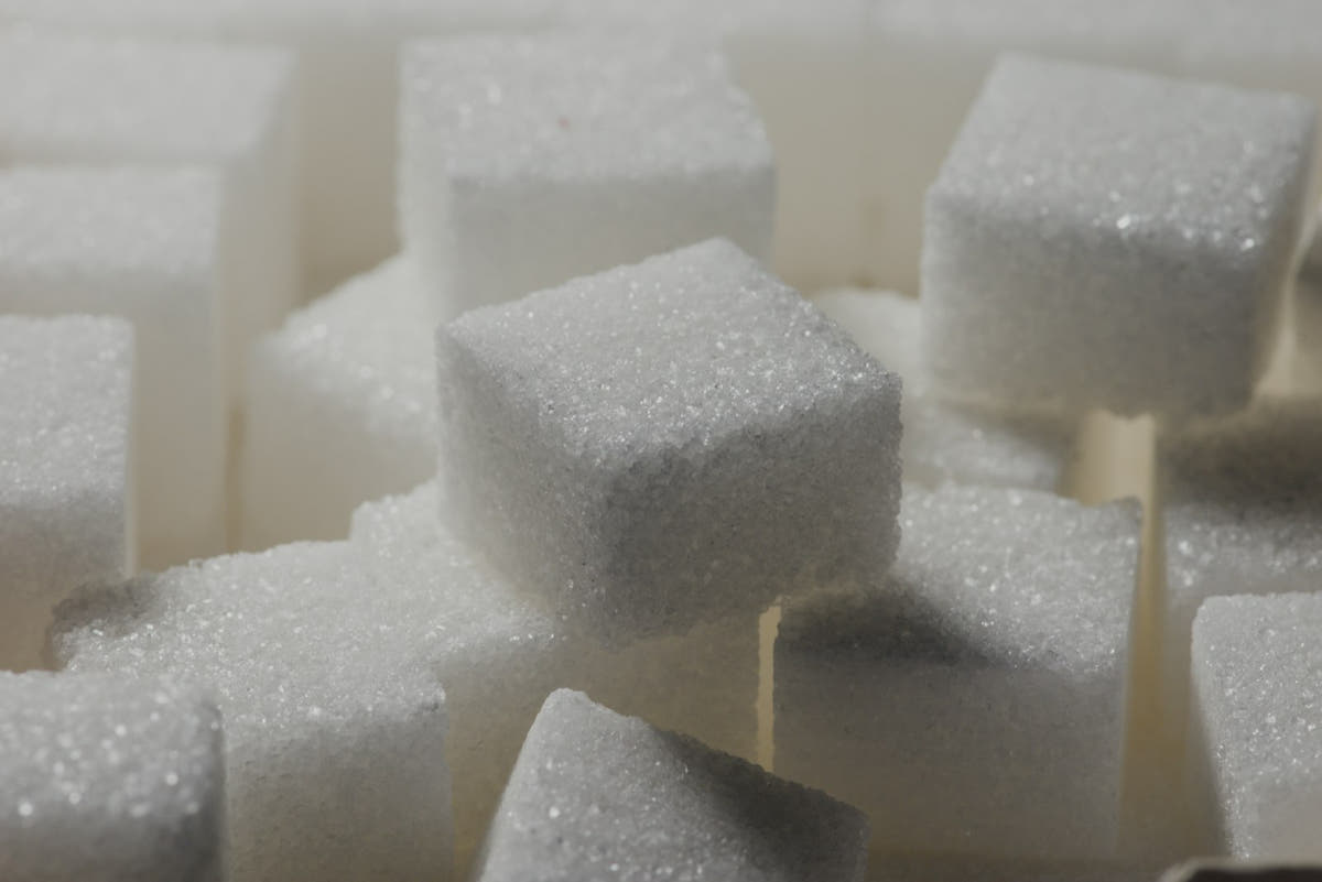 A close-up pile of white sugar cubes